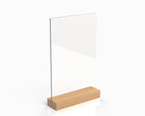 A wooden menu stand with a clear acrylic panel on top of a wooden base.