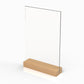 angled side view of a wooden menu stand with a clear acrylic panel on top of a wooden base.
